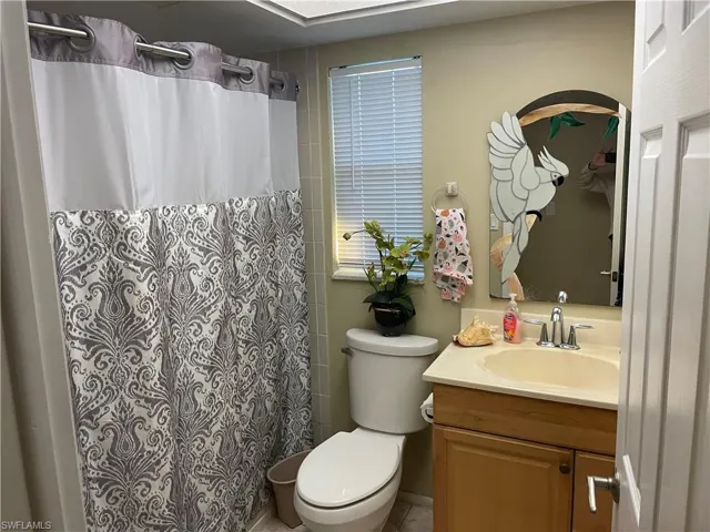 Full bathroom featuring vanity and curtained shower