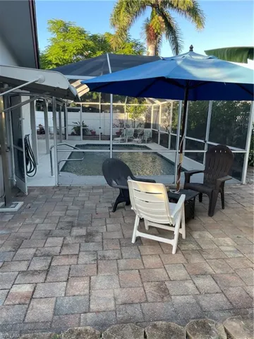 Fenced backyard with a lanai, a patio, and a sunroom