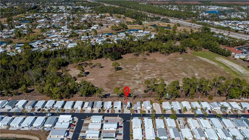 Aerial overview of property's location featuring nearby suburban area