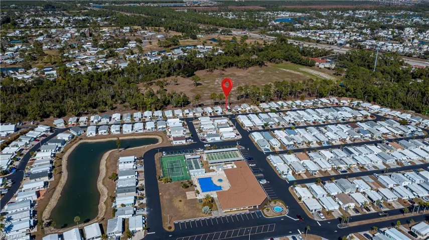 Aerial view of property's location with nearby suburban area and a large body of water