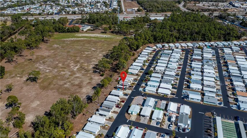 Aerial view of property and surrounding area with nearby suburban area