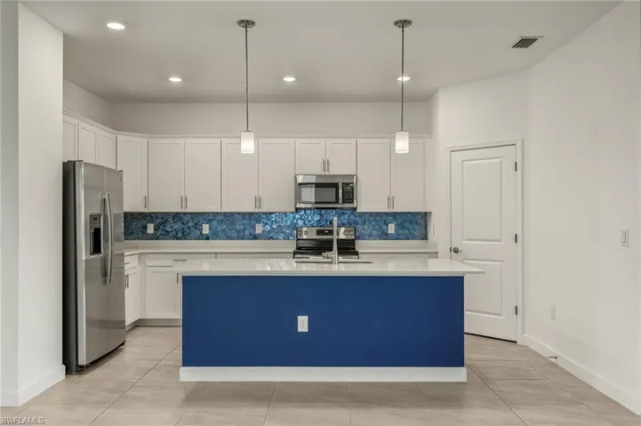Kitchen featuring upgraded backsplash