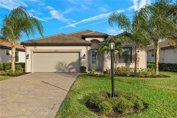 View of front of house with a 2 car garage and oversized driveway