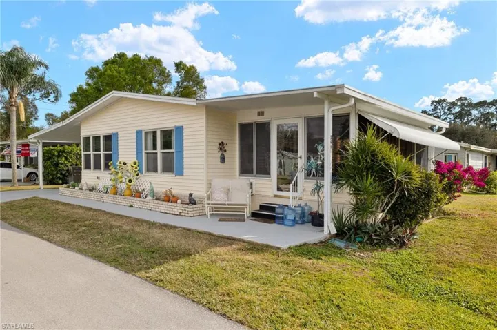 View of front of property with a patio area and a front yard
