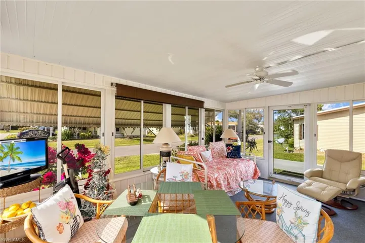 Sunroom / solarium featuring ceiling fan