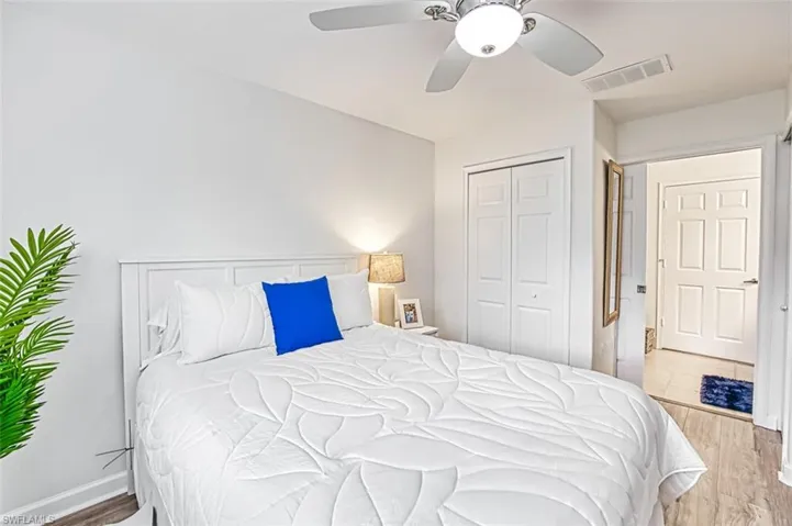 Bedroom featuring light hardwood / wood-style floors, a closet, and ceiling fan