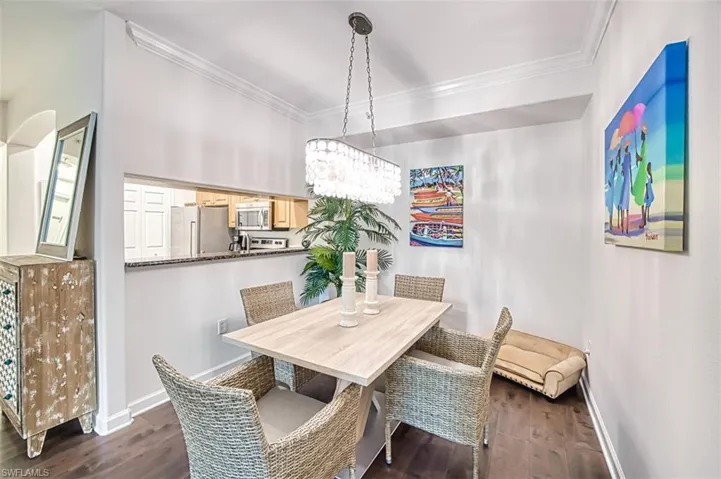 Dining area featuring crown molding and dark hardwood / wood-style floors