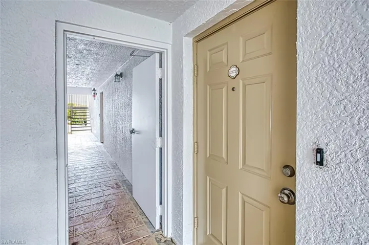 Hallway featuring a textured ceiling