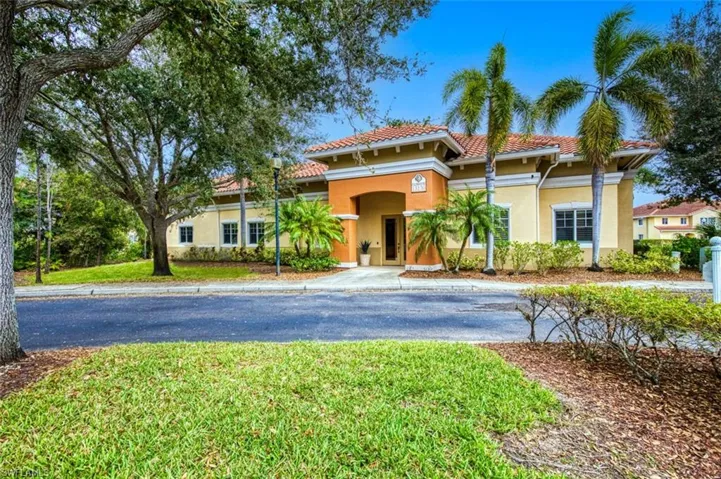 Mediterranean / spanish home with a front yard