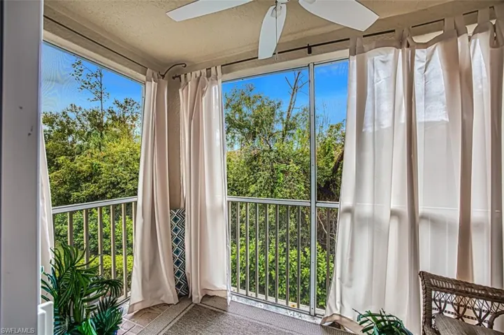 Unfurnished sunroom featuring ceiling fan