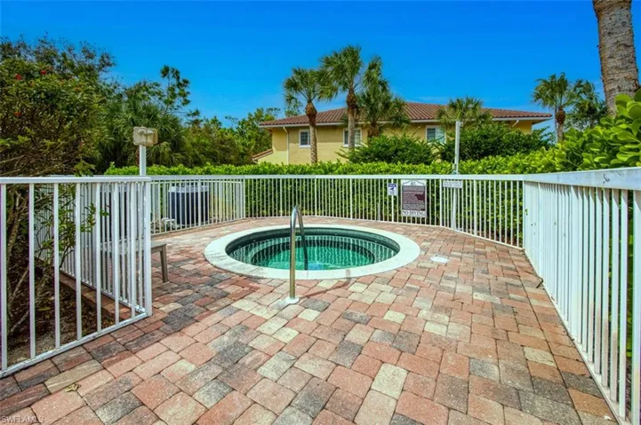 View of swimming pool featuring a hot tub and a patio area