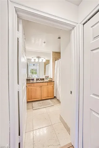 Bathroom featuring vanity, a shower with shower curtain, and tile patterned flooring