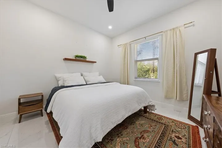 Bedroom in guest home featuring fan, and recessed lighting