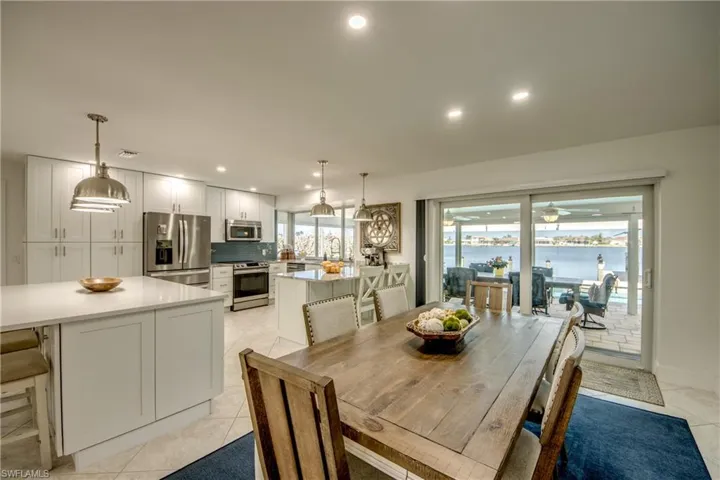Tiled dining room featuring sink