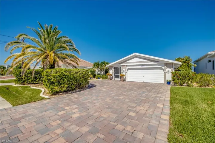 View of front of home featuring a garage and a front yard