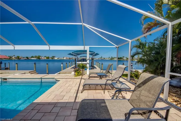View of pool with a water view, a lanai, and a patio