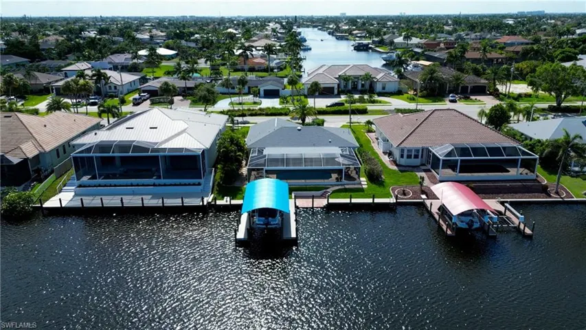 Birds eye view of property with a water view