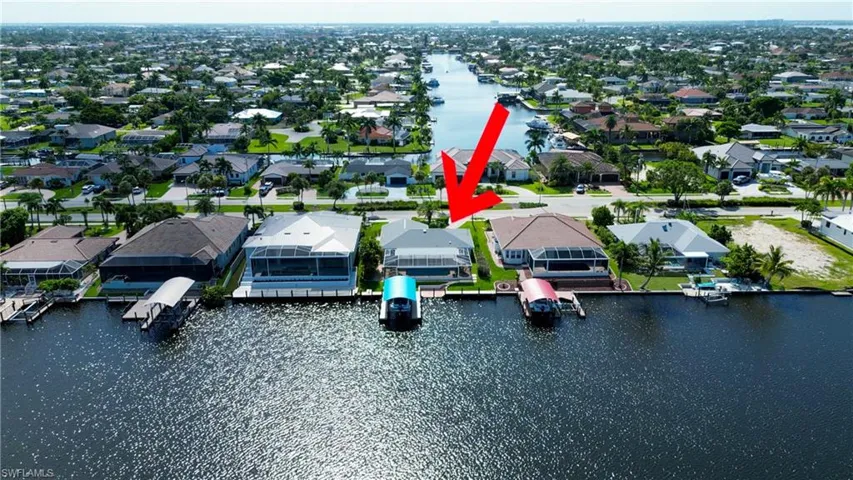 Birds eye view of property with a water view