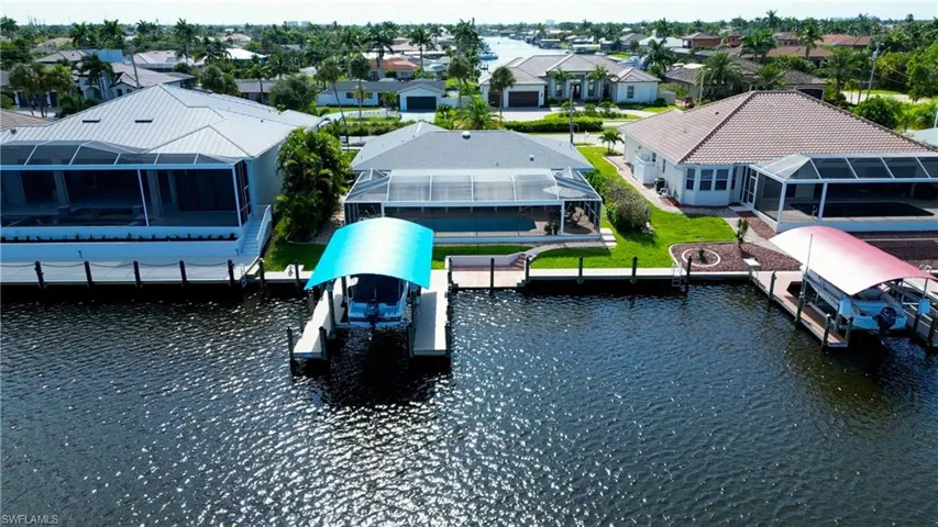 View of dock featuring glass enclosure and a water view