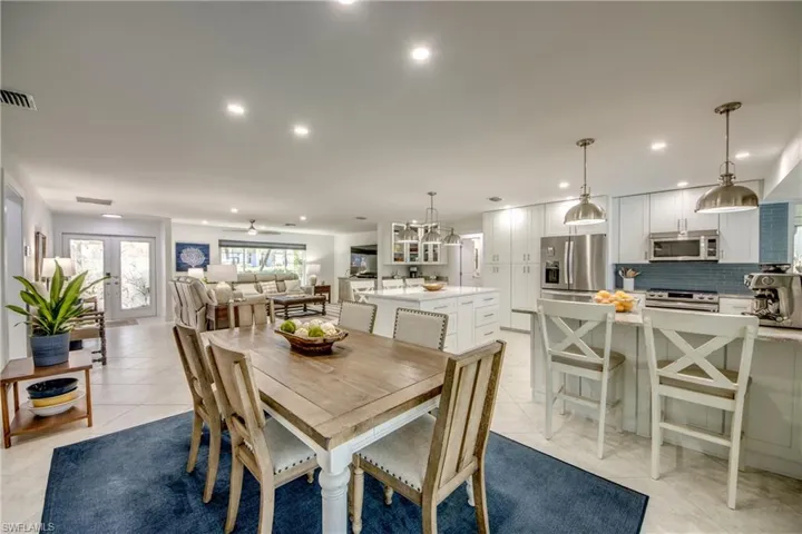 Dining area featuring french doors and light tile patterned floors