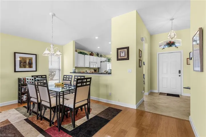 Dining area featuring light wood finished floors and a chandelier