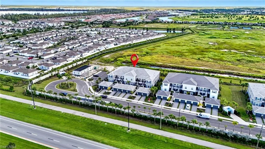 Aerial view of residential area featuring a nearby body of water
