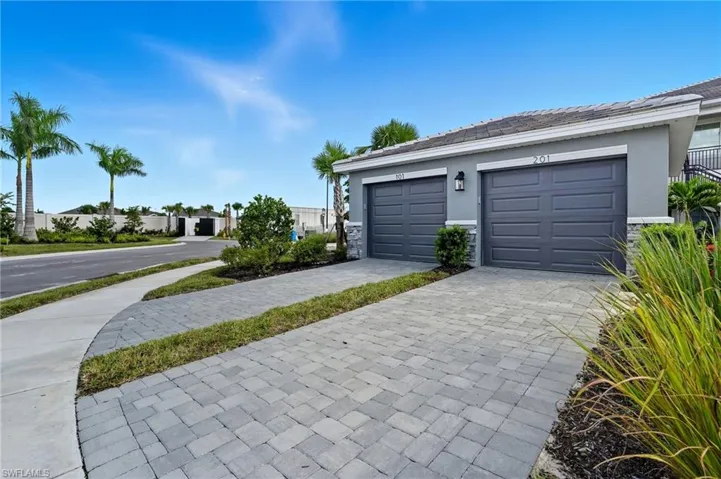 Garage featuring decorative driveway