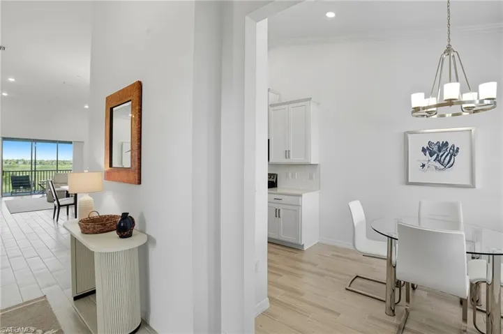 Dining space with recessed lighting, wood finish floors, and a chandelier