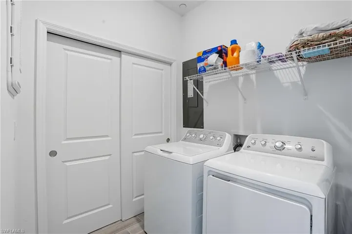 Washroom featuring independent washer and dryer and light wood-style floors