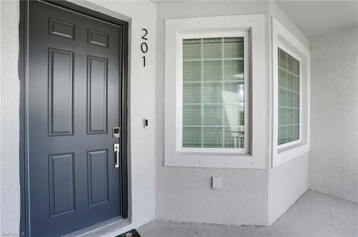 Property entrance featuring stucco siding