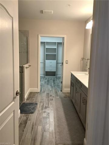 Long hallway in master bath leading to oversized  closet