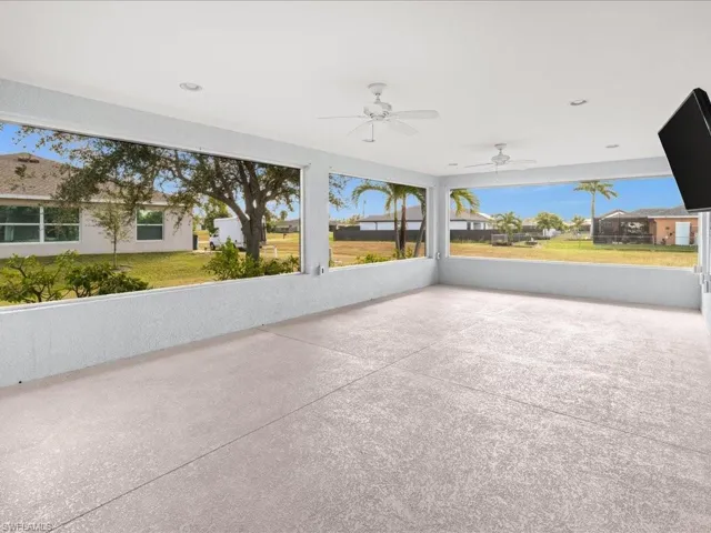 View of patio / terrace with ceiling fan, a residential view, and a sunroom