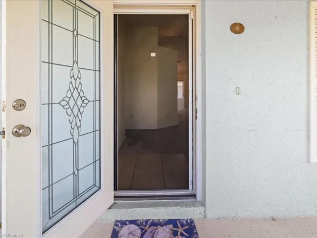 Property entrance with stucco siding