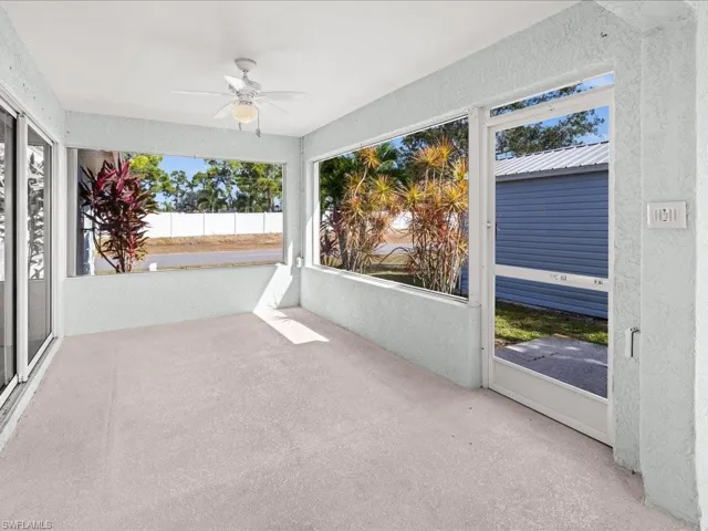 Unfurnished sunroom featuring a ceiling fan