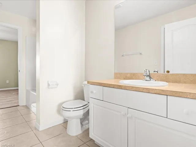 Jack and Jill Bathroom featuring light tile patterned floors,  vanity, and bathtub / shower combination
