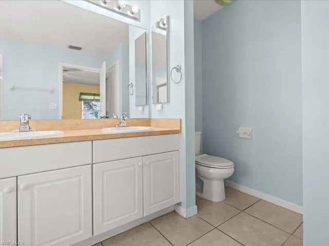 Master Full bath featuring light tile patterned floors and double vanity