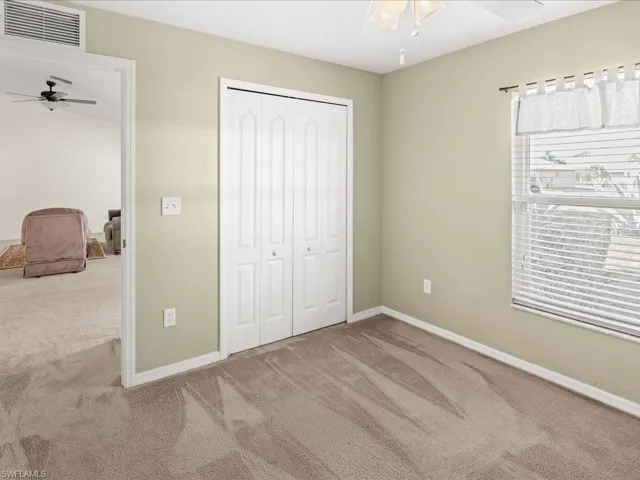 Unfurnished bedroom with carpet flooring, a ceiling fan, and a closet