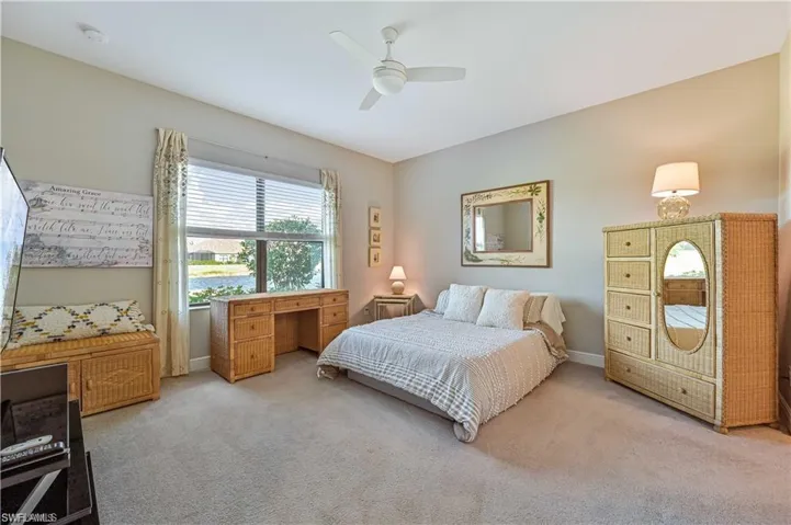 Carpeted bedroom with ceiling fan