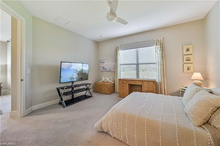 Bedroom with light carpet and ceiling fan