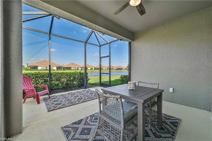 View of patio / terrace featuring ceiling fan and a lanai