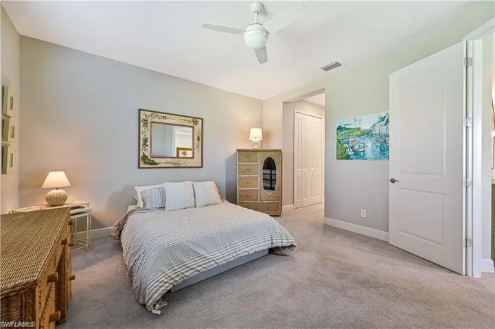 Bedroom featuring ceiling fan, a closet, and carpet flooring
