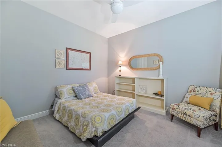 Bedroom featuring light carpet and ceiling fan