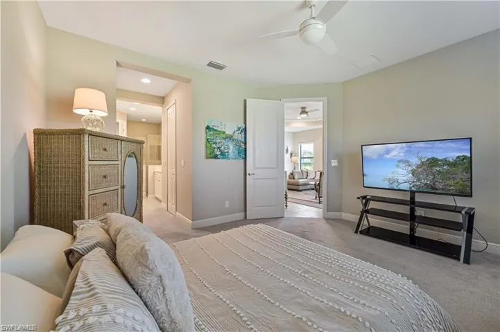 Bedroom featuring ceiling fan and light colored carpet