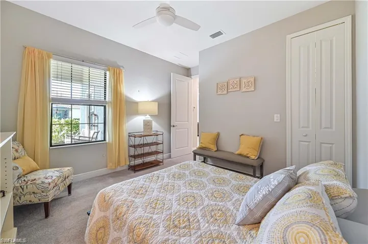 Carpeted bedroom with a closet and ceiling fan