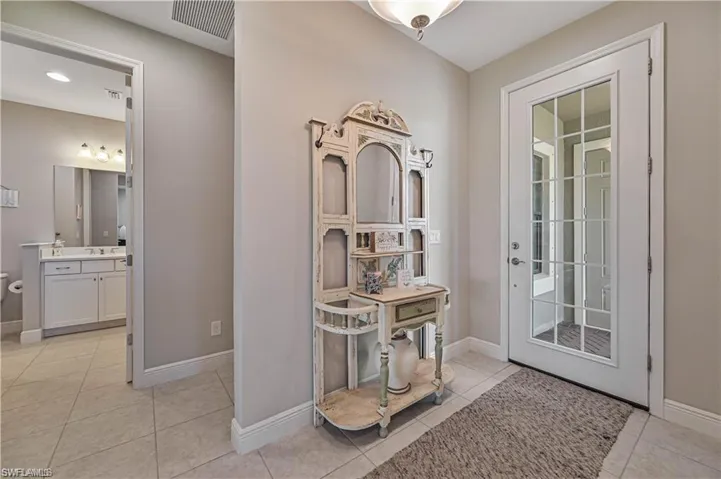 Doorway with light tile patterned floors