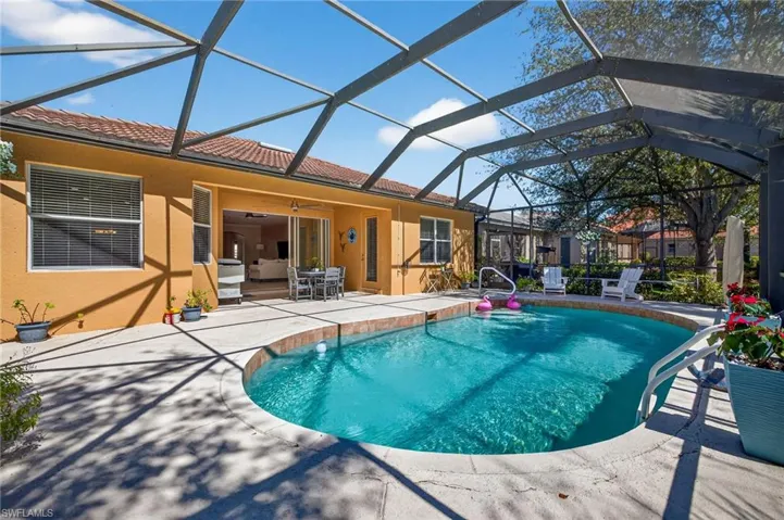 Swimming pool with a patio, a lanai, a sunroom, and outdoor dining space