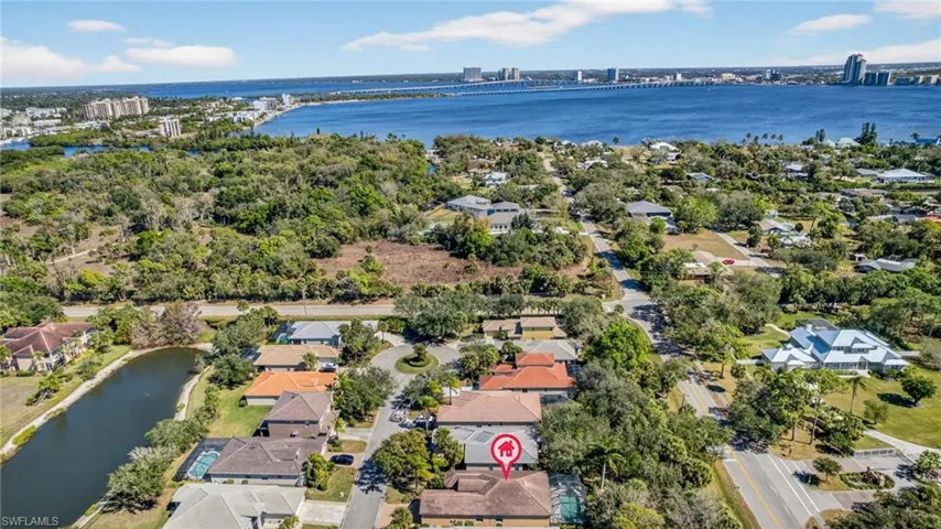 Aerial perspective of suburban area with a nearby body of water