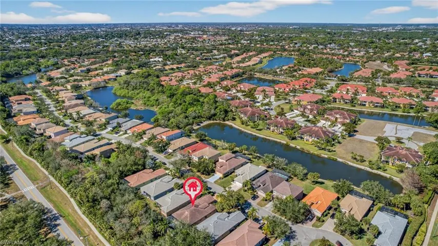 Aerial view of property and surrounding area with nearby suburban area and a large body of water