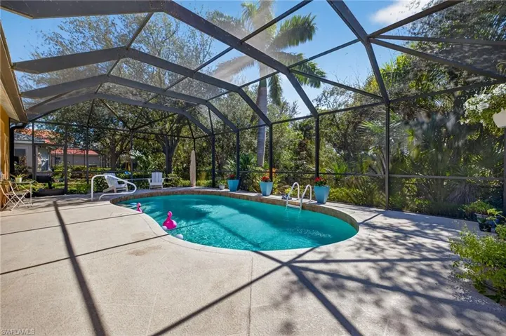 Outdoor pool with a lanai, and a patio area