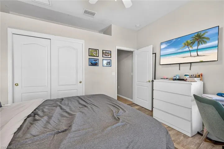 Bedroom featuring light wood-type flooring, a ceiling fan, and a closet